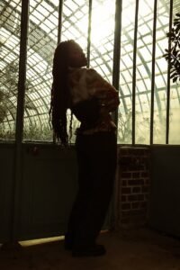 A woman standing in front of a glass wall