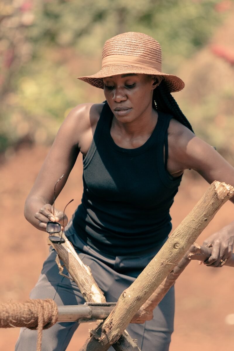 A woman holding a stick and a wooden stick